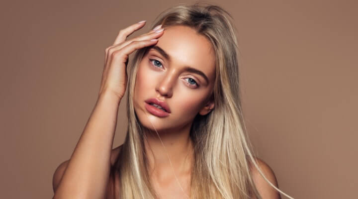 beautiful young woman touching face